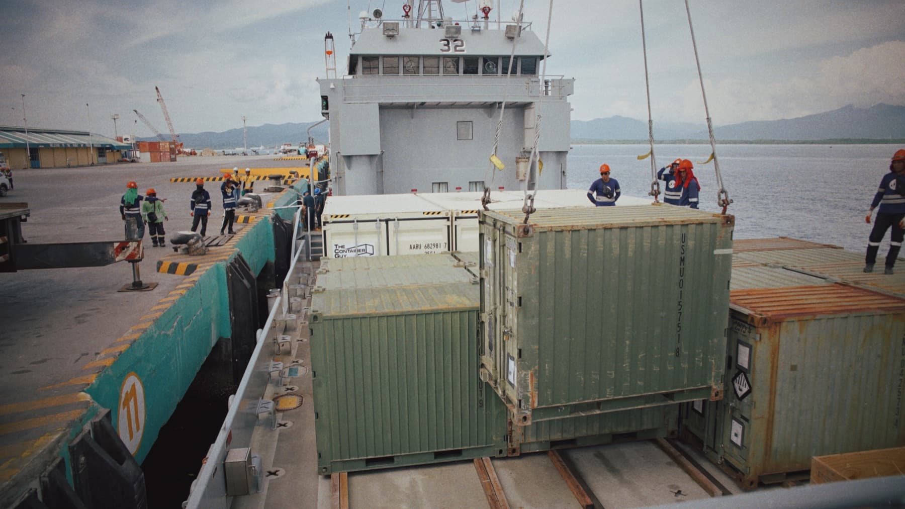 Army watercraft crew moving containers during a port operation