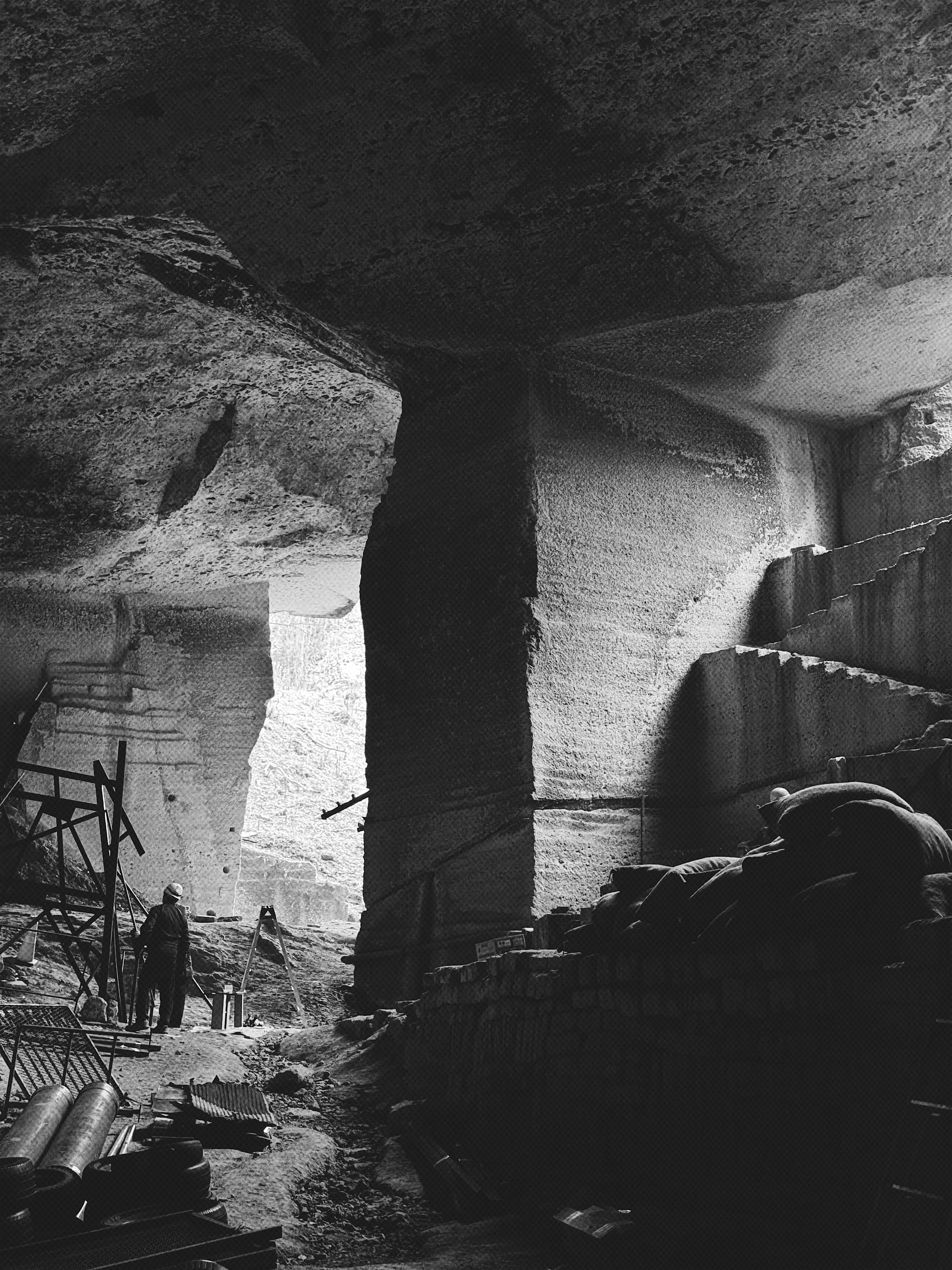 A black and white underground stone chamber