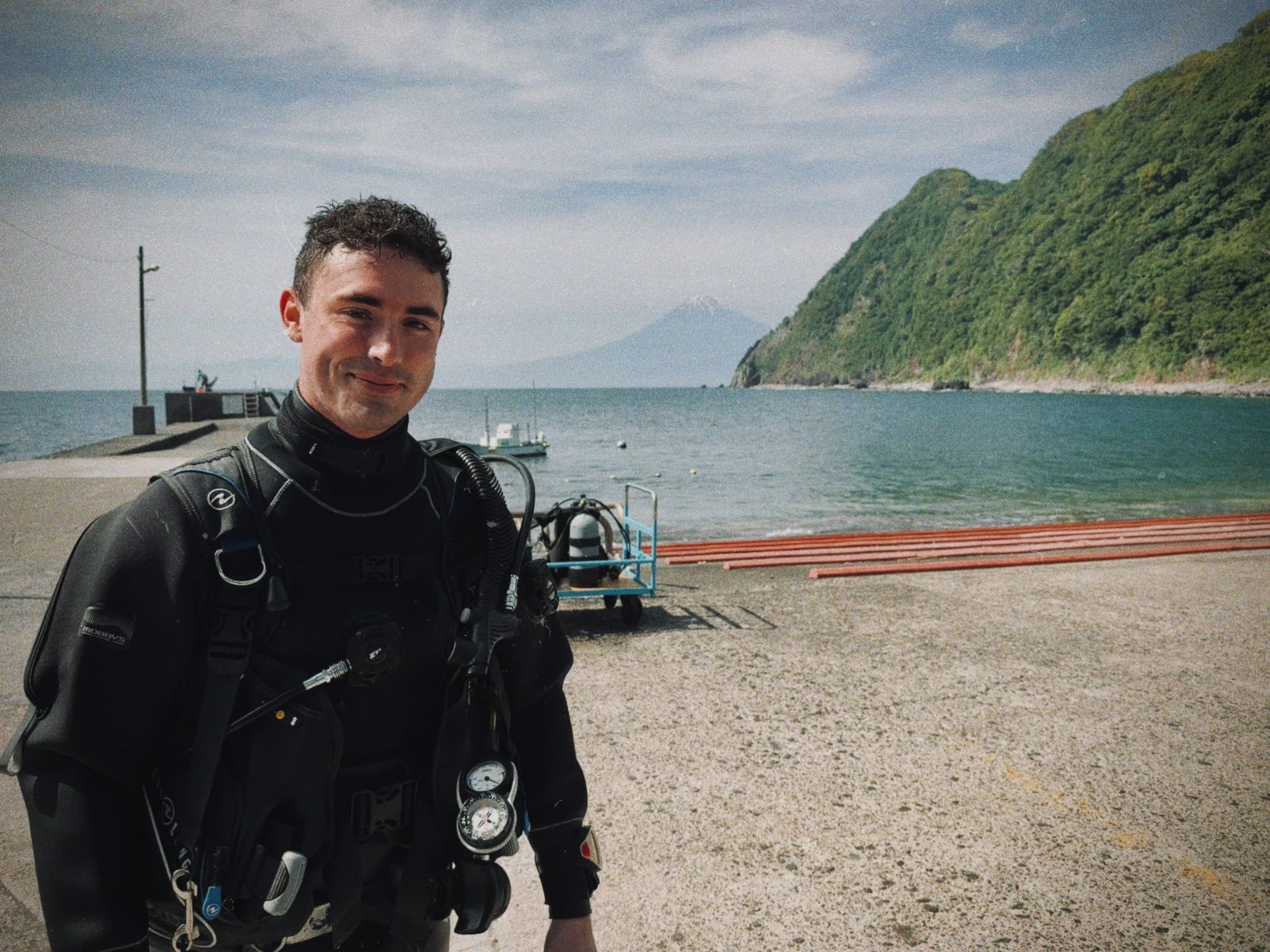 A diver beside a quiet harbor